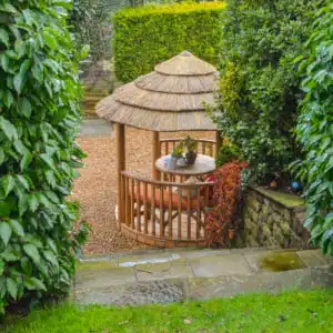 Mara Breeze House with thatched roof in a garden