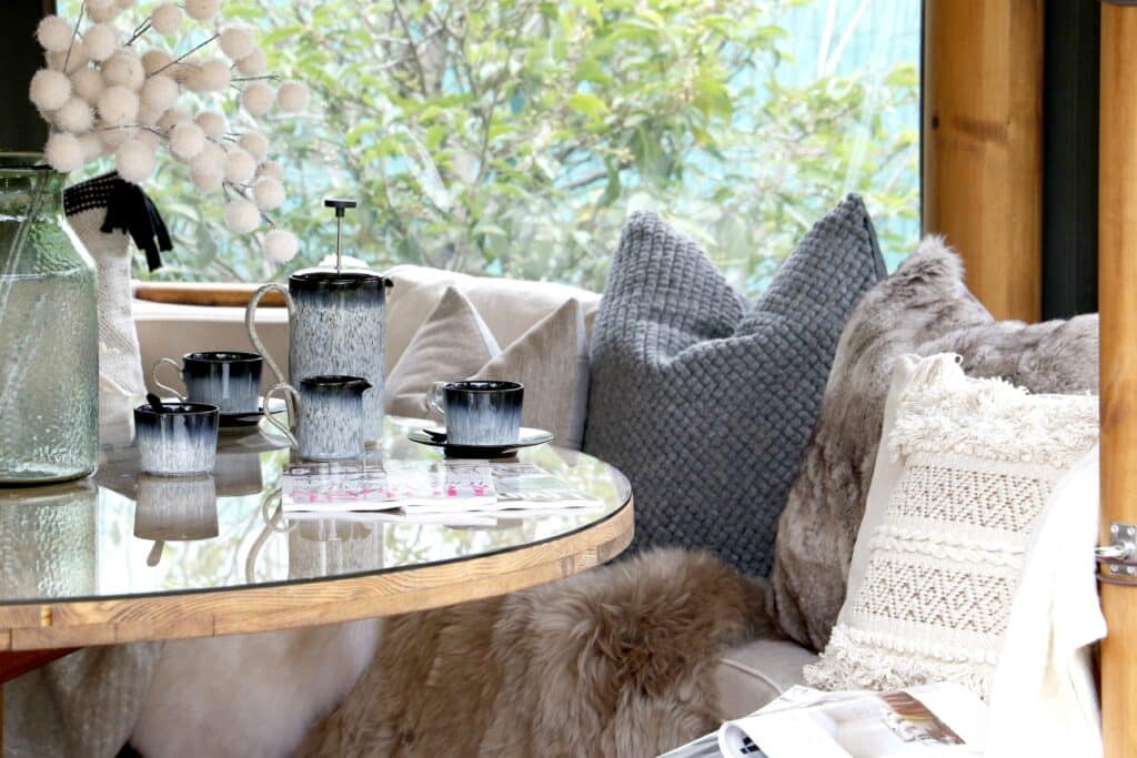 Interior of a Breeze House style for winter with faux fur cushions and cost throws