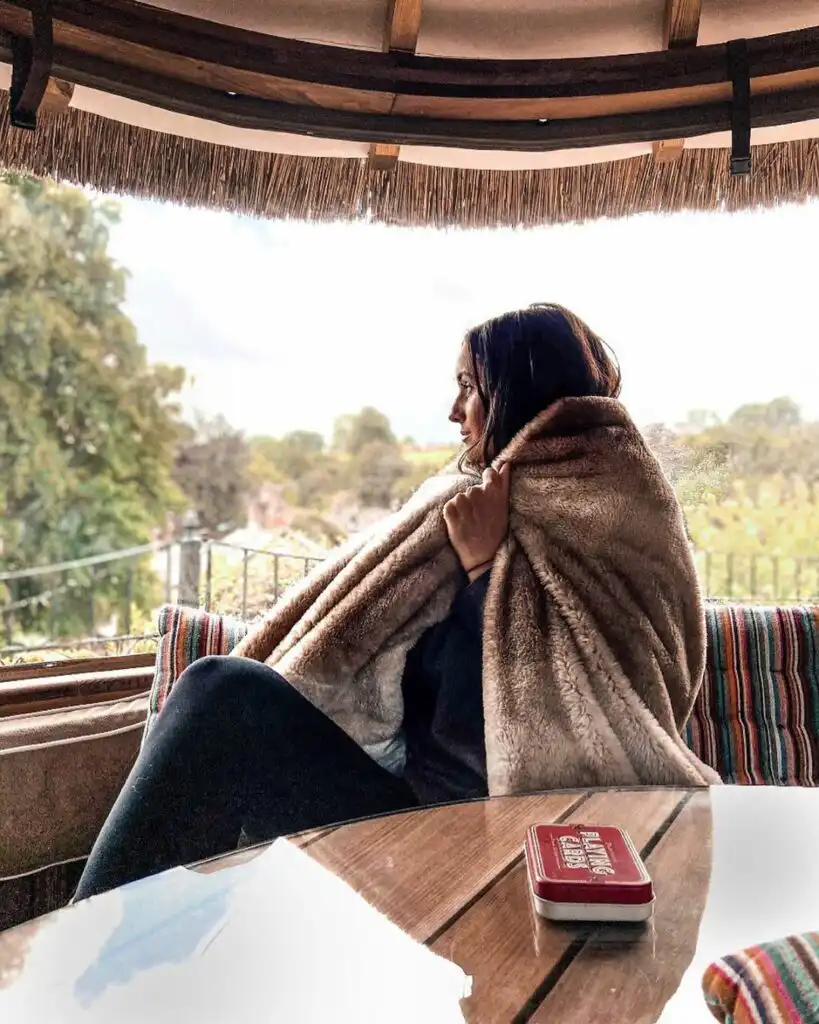 Person wrapped in blanket in a Breeze House