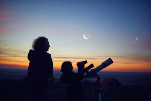 Family observing the stars, on a perfect autumn evening with telescope