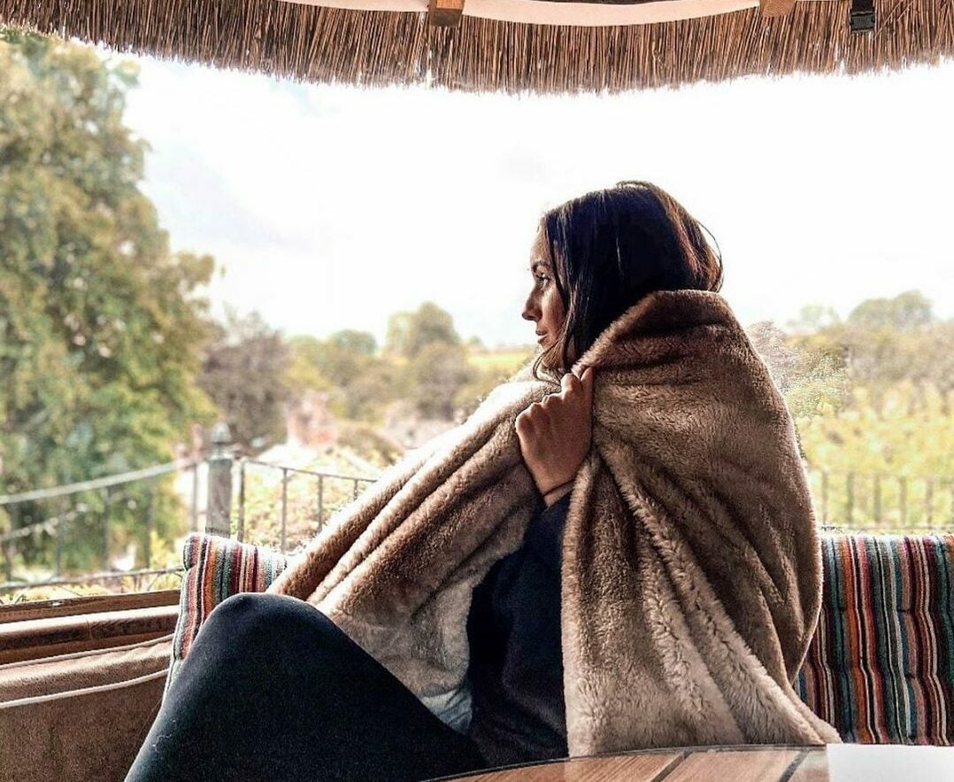 Person wrapped in blanket in Breeze House