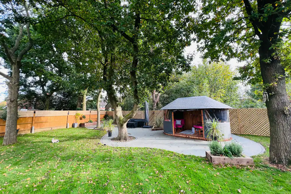Oval Breeze House in a garden