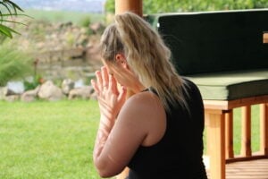 Person meditating in a Breeze House gazebo