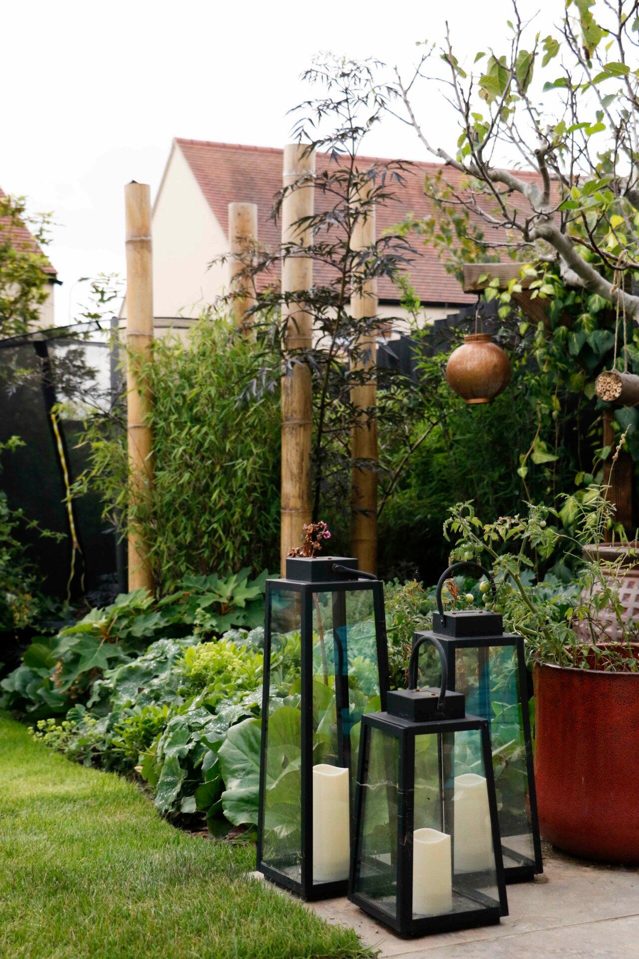 Garden metal lanterns containing candles