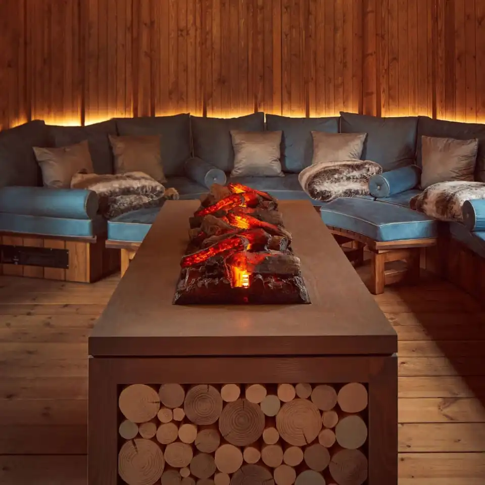 inside of breeze house with seating and center artificial wood outdoor heater