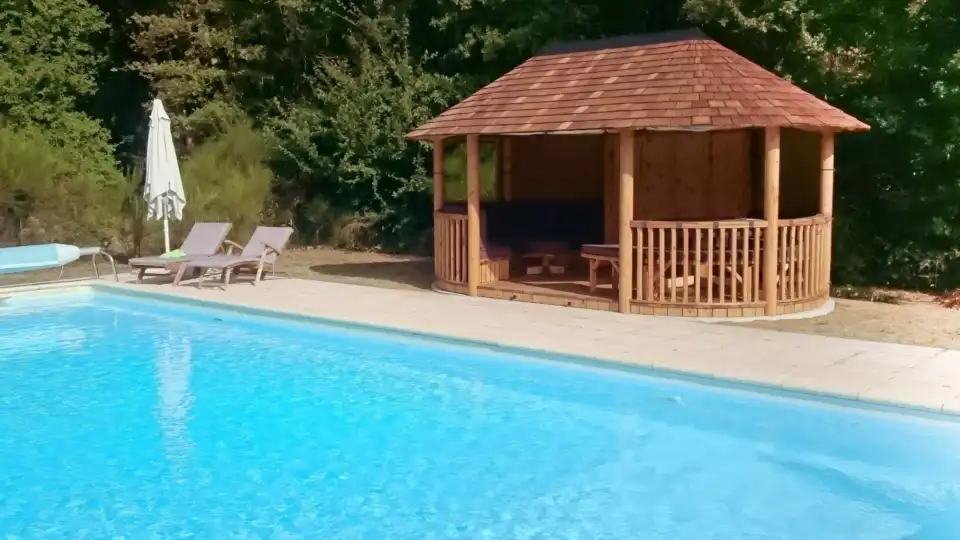 breeze house garden building placced next to swimming pool