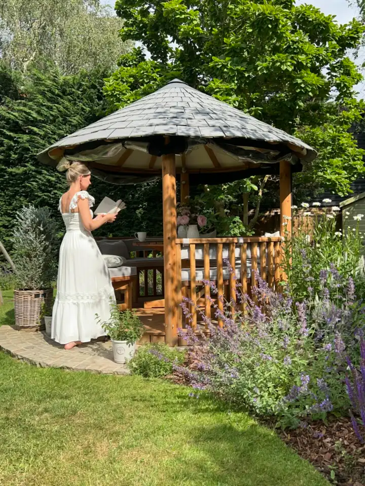 Person walking barefoot next to Breeze House gazebo