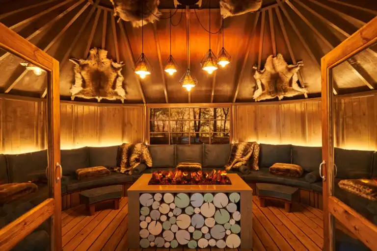 Scandinavian Snug with a central glowing fire at Aqua Sana