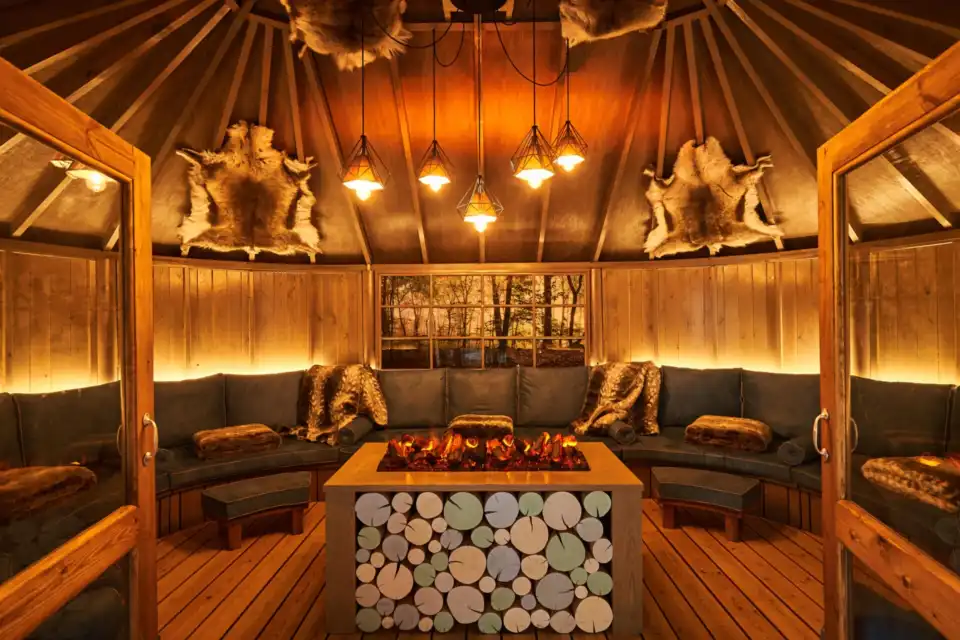 Scandinavian Snug with a central glowing fire at Aqua Sana