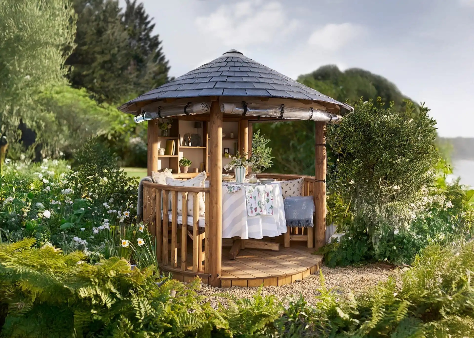 sophie allport collaboration with breeze house building in garden surrounded by flowers