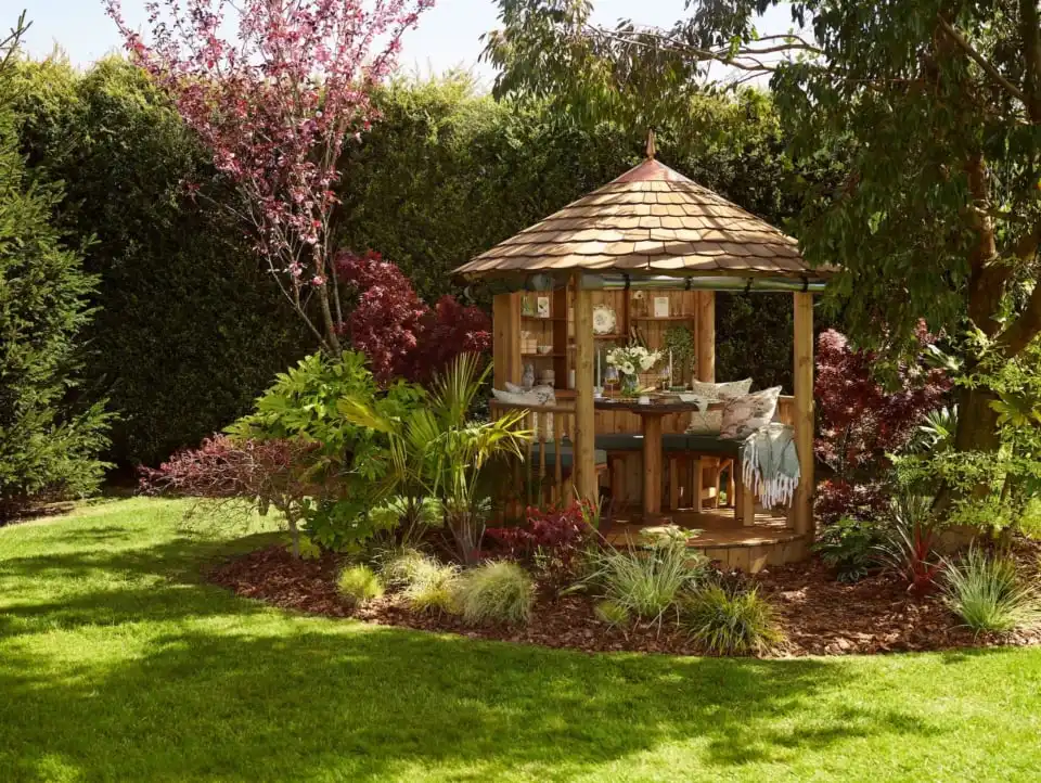 RHS breeze house building with dining configuration featuring bench seating and table